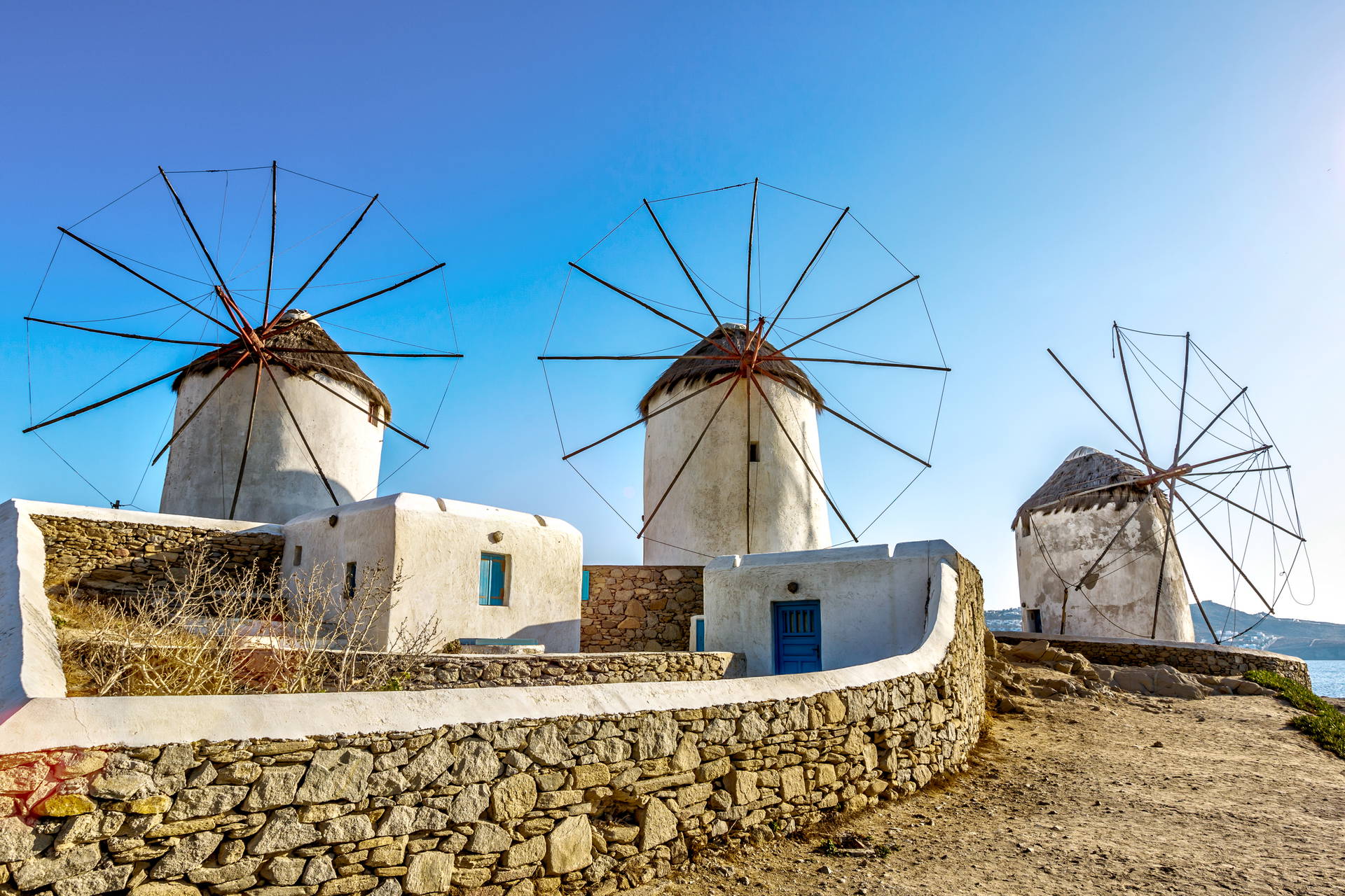 Trzy wiatraki na Mykonos na tle błękitnego nieba.