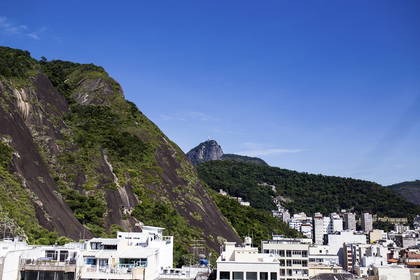 Krajobraz Rio de Janeiro z budynkami, górą i pomnikiem Chrystusa Odkupiciela.