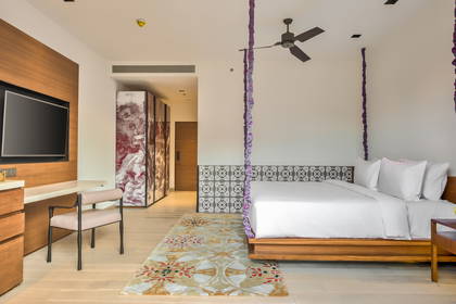 Pokój hotelowy z łóżkiem, biurkiem i szafą.
