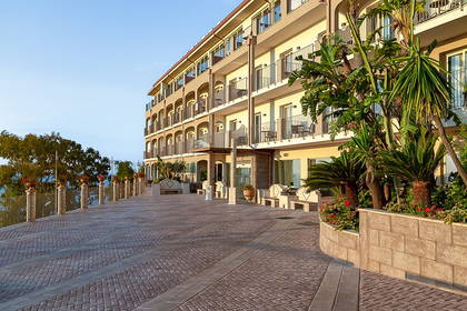 Hotel z balkonami ozdobionymi roślinami.
