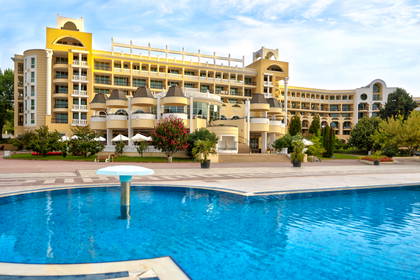 Hotel z basenem na pierwszym planie.