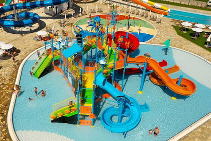 Kolorowy park wodny z basenami i zjeżdżalniami, widok z góry.