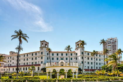 Hotel z dwiema wieżami otoczony palmami.