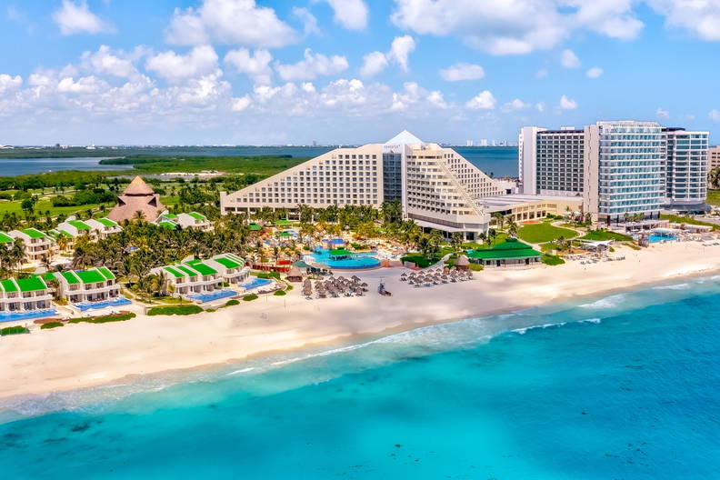 Luksusowy kurort z plażą i turkusowym oceanem widziany z lotu ptaka.