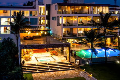 Hotel z basenem oświetlonym nocą.