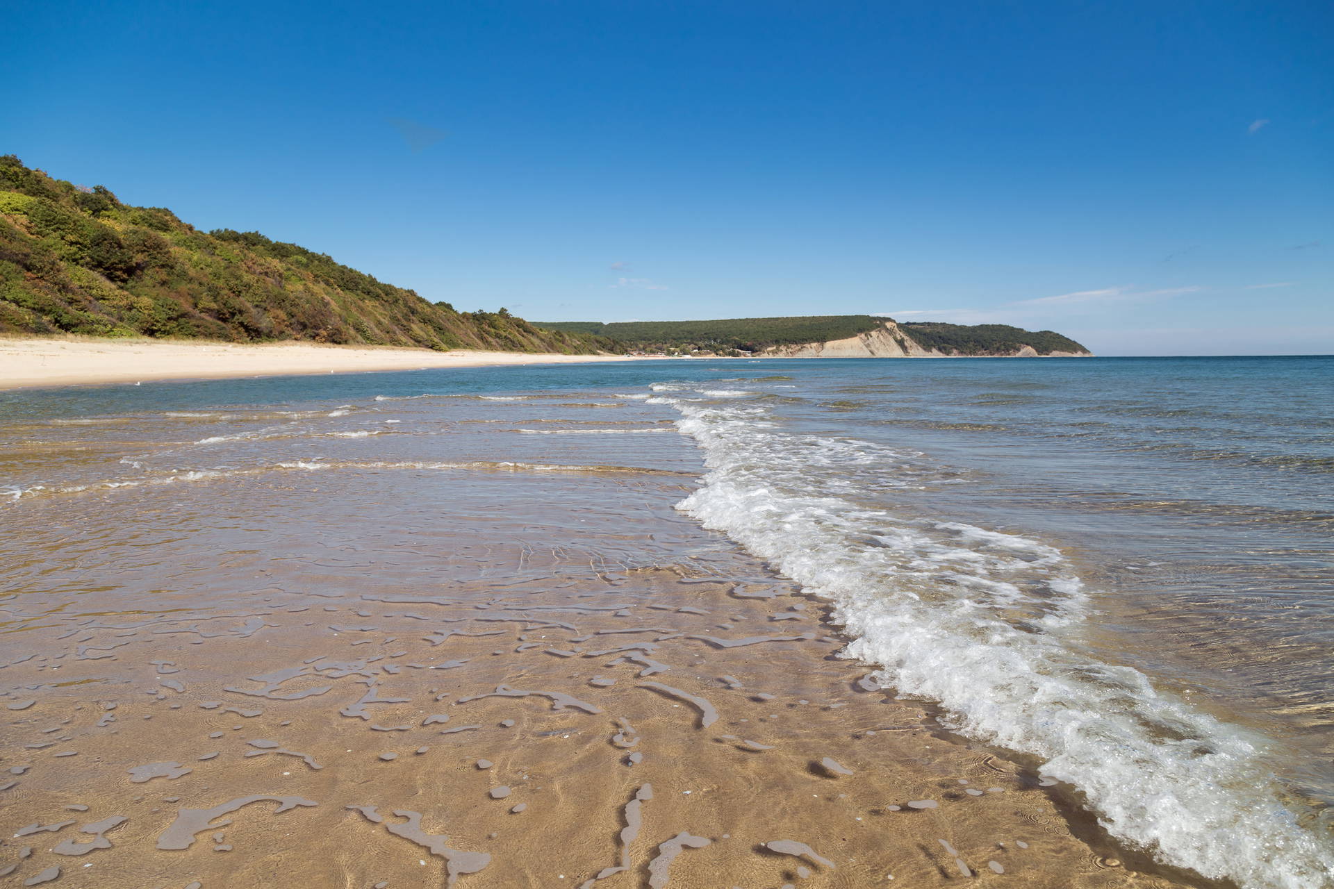 Słoneczna plaża z falami.