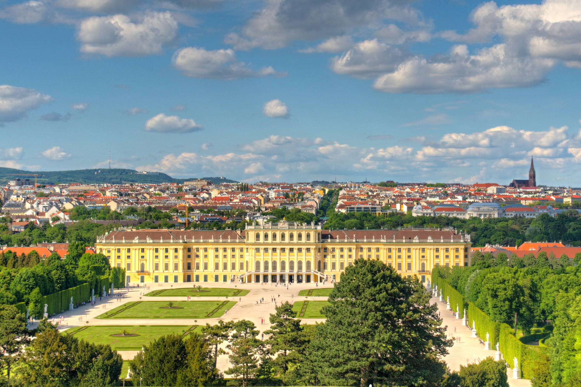 Pałac Schönbrunn i rozległe ogrody w słoneczny dzień.