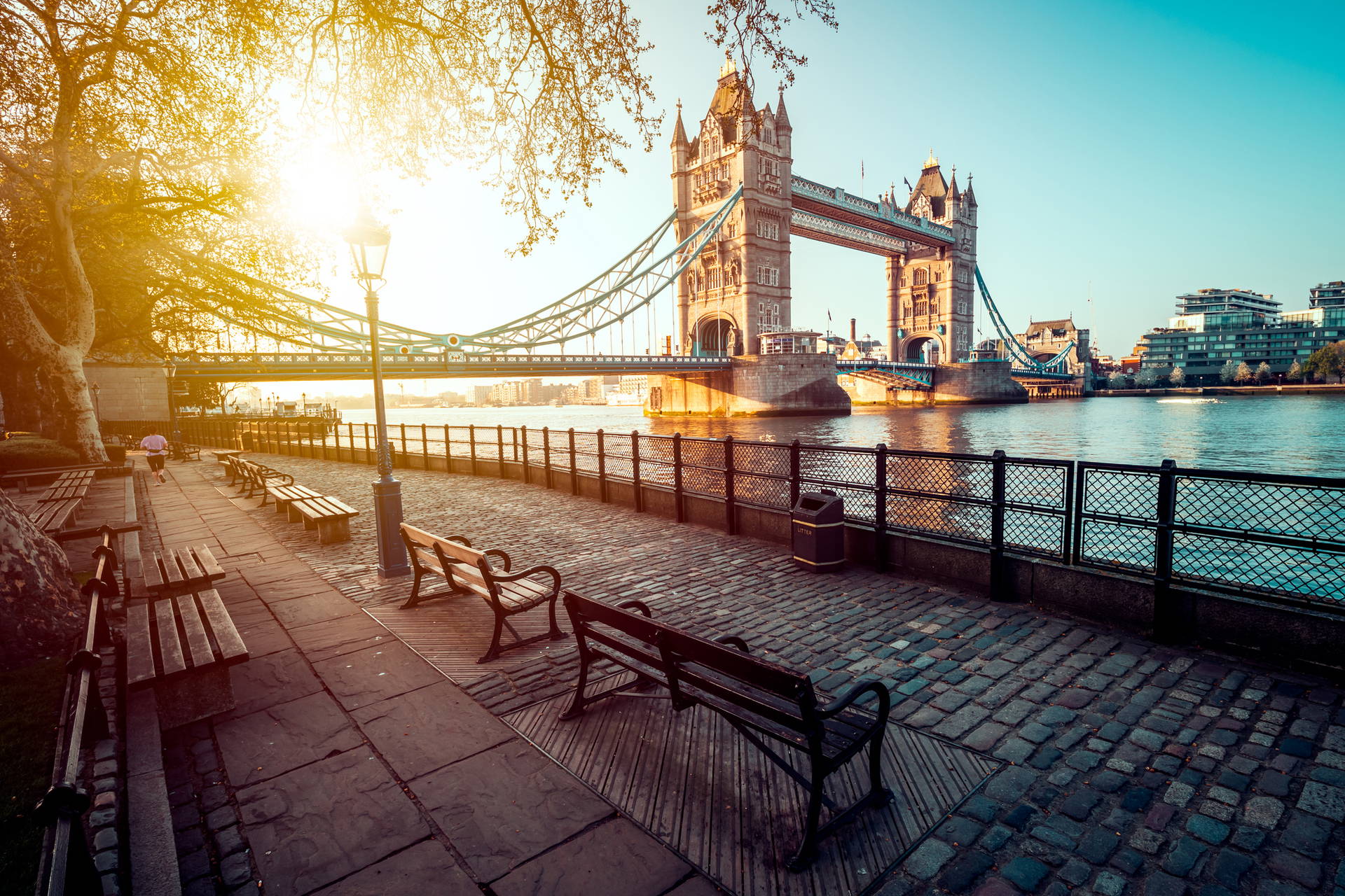 Tower Bridge w Londynie widziany z bulwaru z ławkami.
