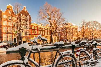 Zimowy Amsterdam. Śnieg pokrywa rowery.