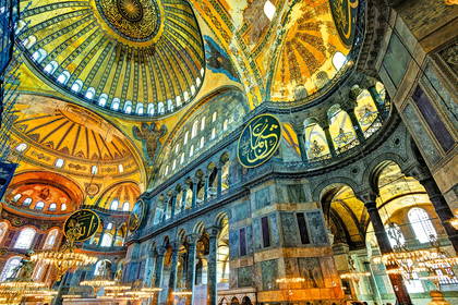 Wnętrze Hagia Sophia w Stambule z bogato zdobioną kopułą i kolumnami.